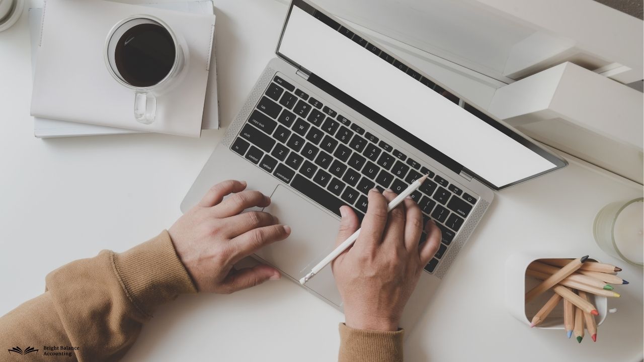 Modern desk, laptop with colorful charts, bright office